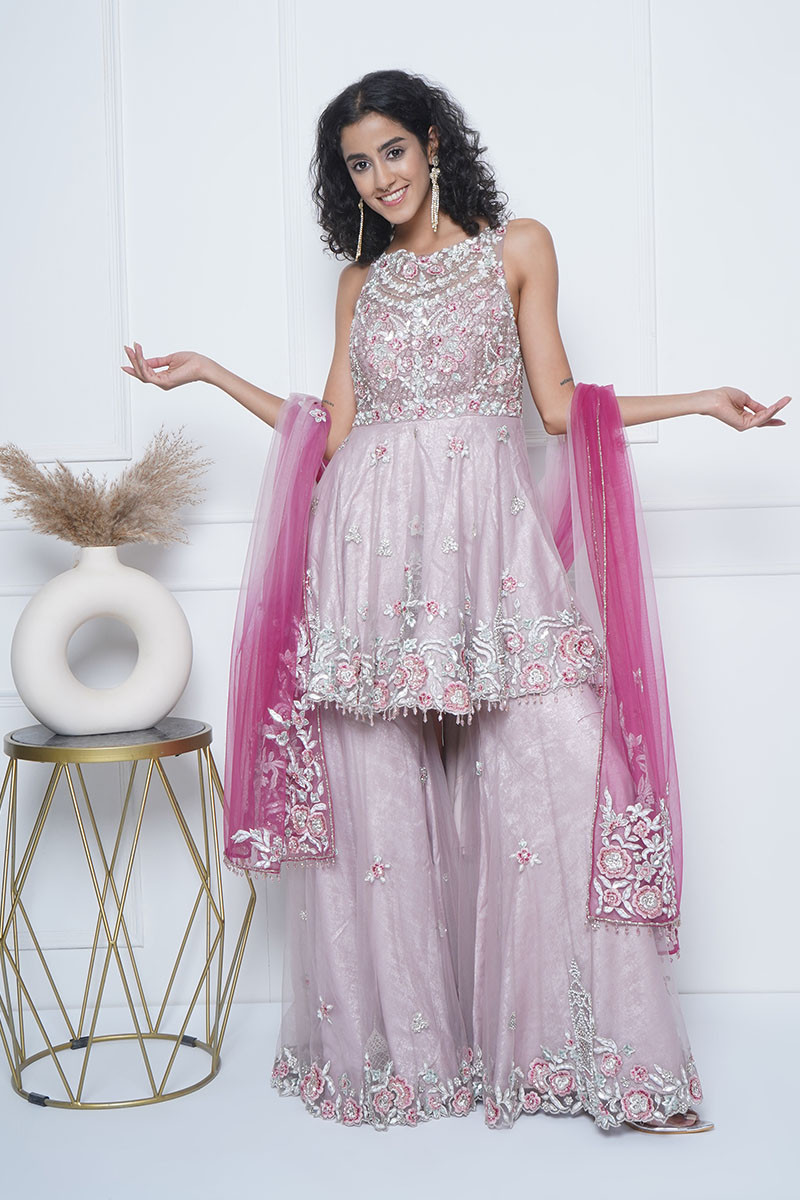 Peach tulle ombre dye esemble, enhanced with beautiful hand floral embroidery on top and gharara bottom and dupatta. Perfect for a special occasion .